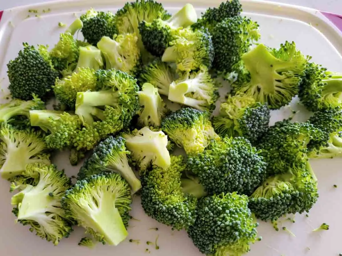 broccoli florets on a cutting board.