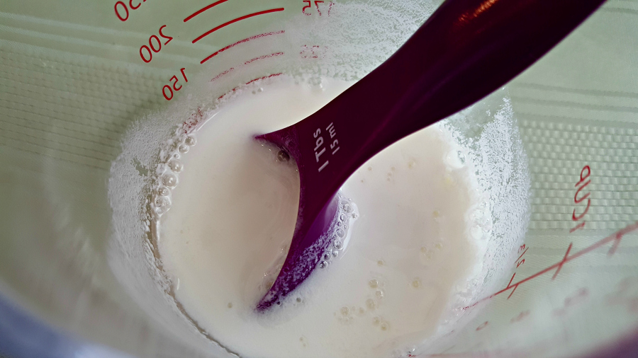 milk and vinegar mixed in a measuring cup.