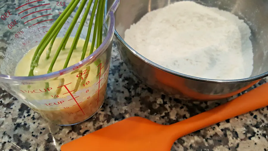 two bowls with dry and wet ingredients separate.