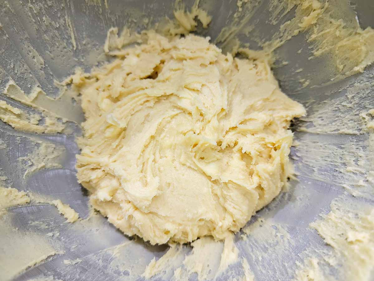 butter, sugar, eggs, vanilla, flour, baking soda, and salt mixed together in a bowl.