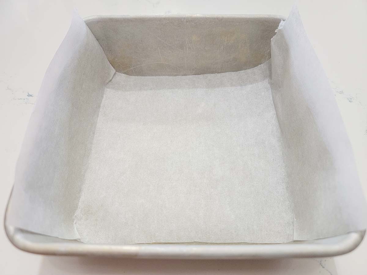 parchment paper lining a cake pan.