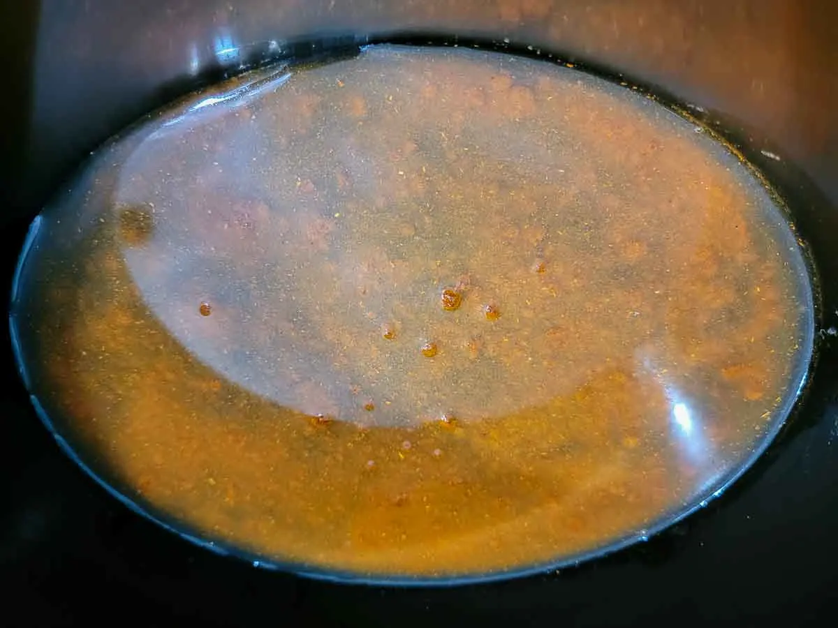 chicken broth and taco seasoning in a crock pot.
