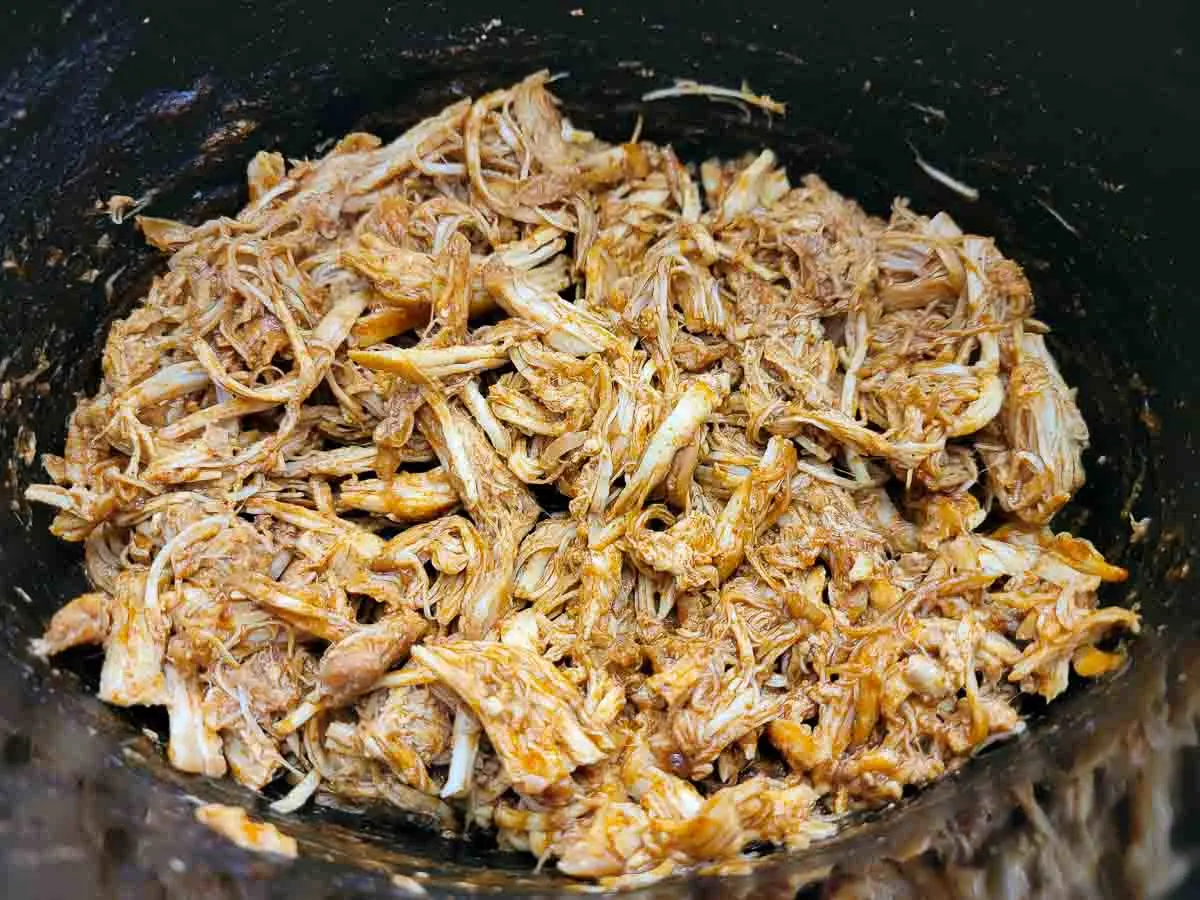shredded chicken taco filling in a slow cooker.