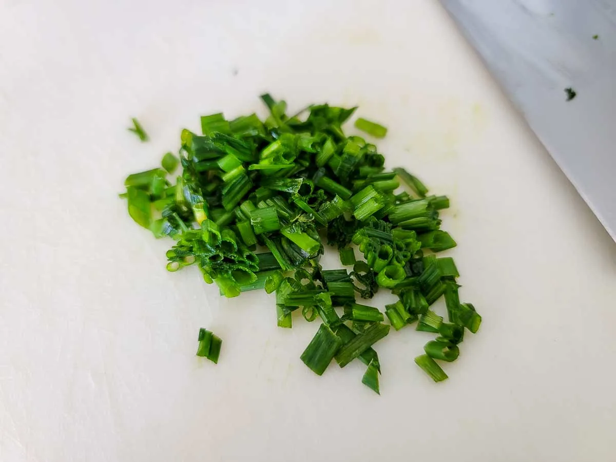 fresh chives chopped on a cutting board.