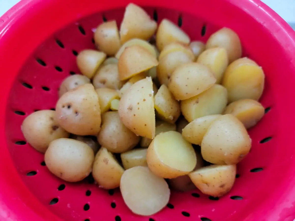 diced baby potatoes draining in a colander.