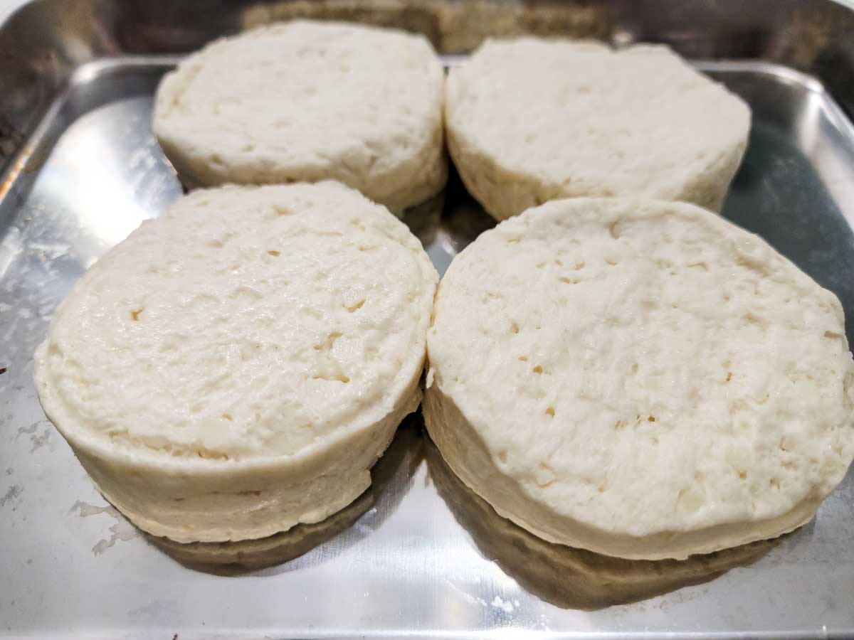4 buttermilk biscuits from a can on a tray.