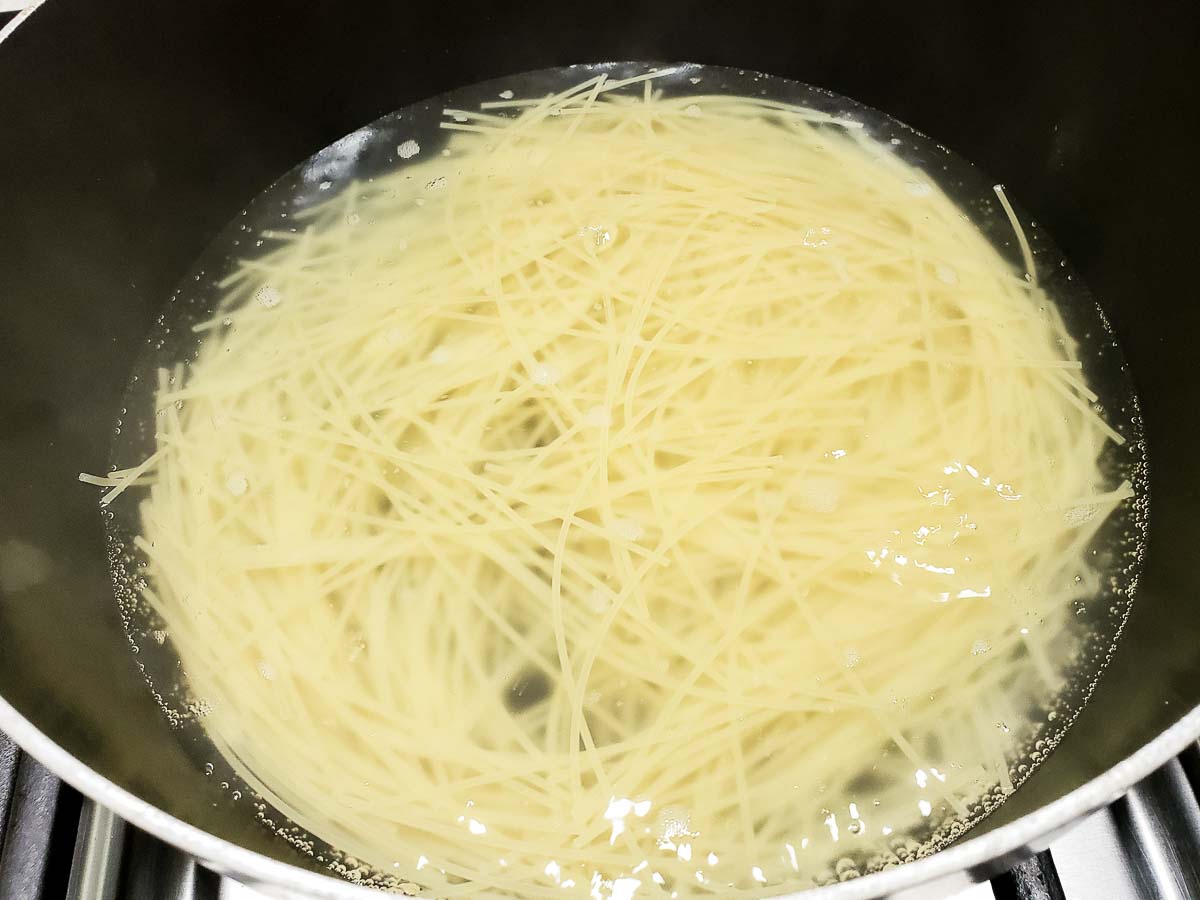 angel hair pasta cooking in a bowl.