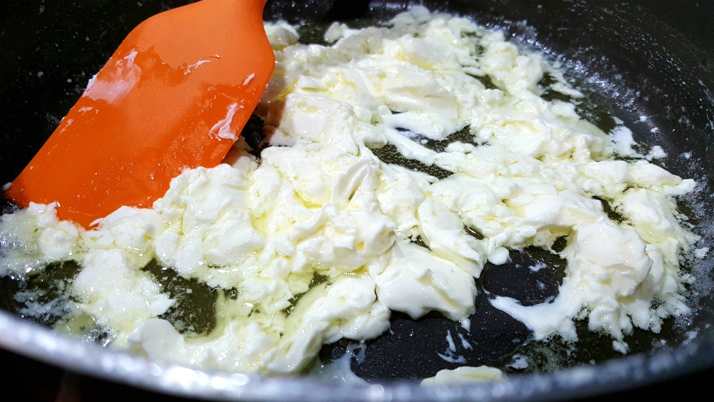 cream cheese and butter cooking in a pan.