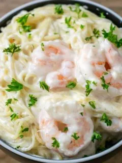 Shrimp Alfredo with Angel Hair Pasta in a bowl.
