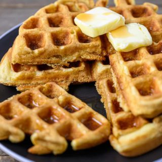 Thick and Fluffy Waffles stacked on a plate.