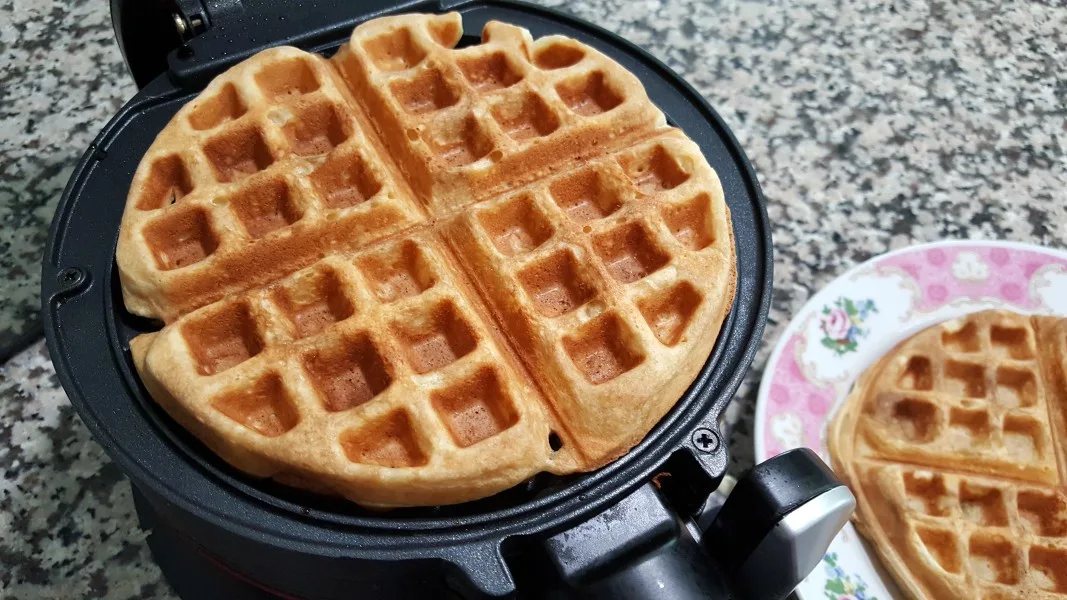 a cooked waffle in a waffle iron.