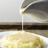 3 Ingredient Gravy being poured over mashed potatoes.