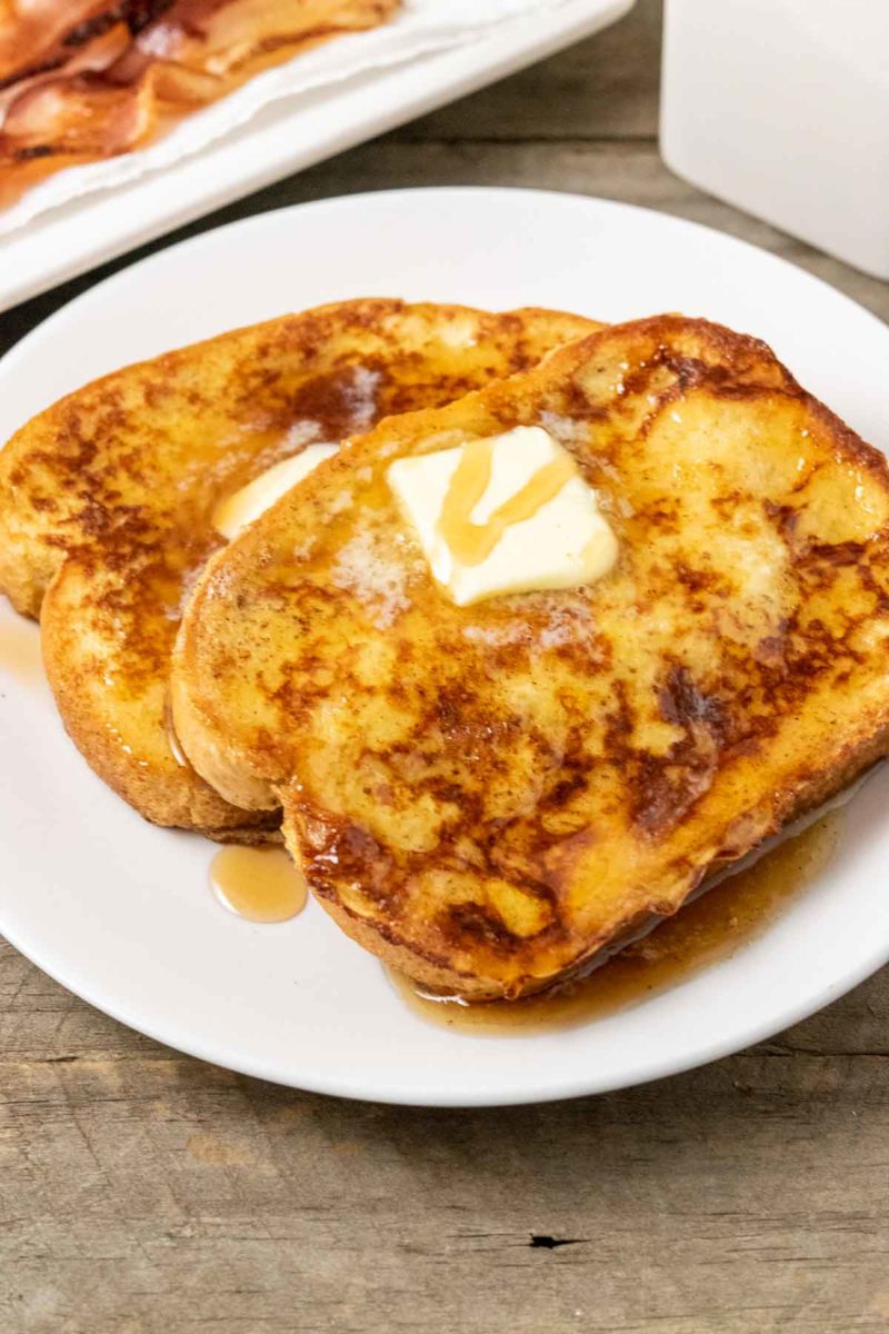 15 Minute Texas French Toast slices on a plate topped with butter and syrup.