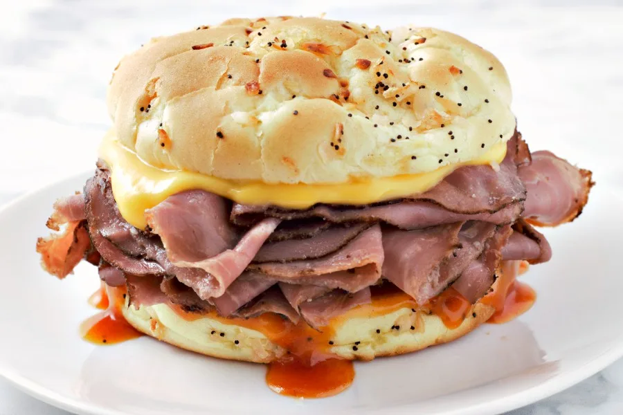 Arby’s Roast Beef and Cheddar sandwich on a plate.