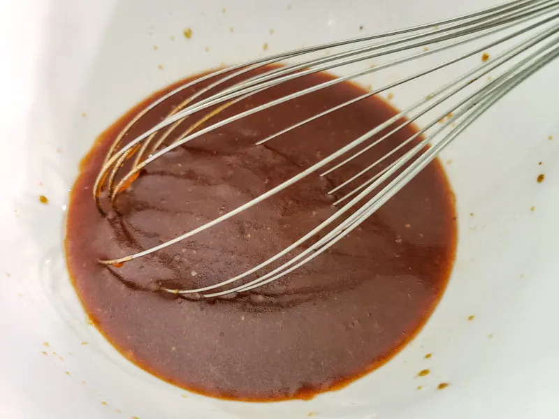 barbecue sauce, Zesty Italian salad dressing, brown sugar, and Worcestershire sauce in a small bowl with a whisk.