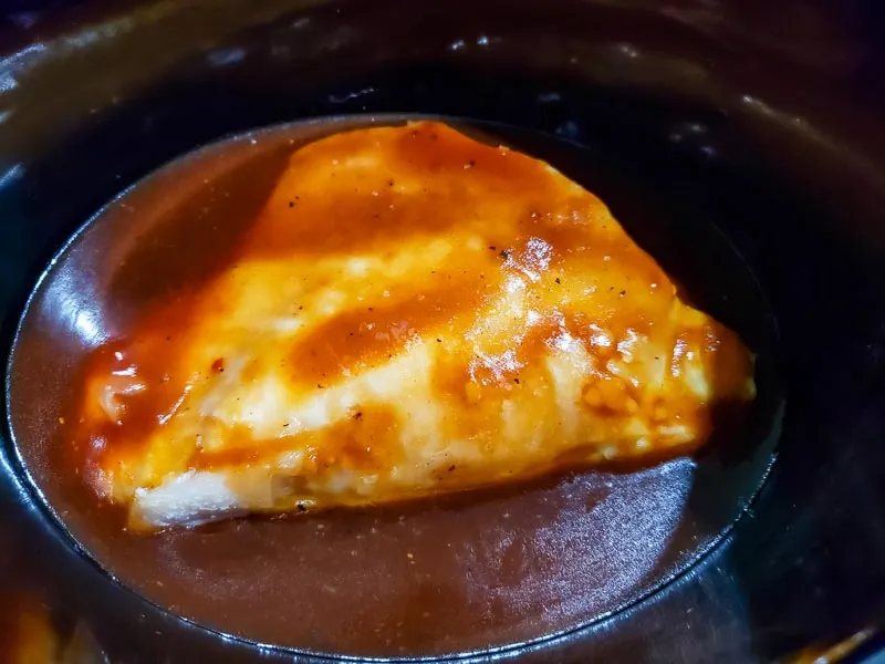 boneless chicken and sauce in a crock pot.