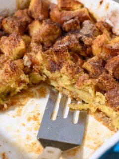 French Toast Casserole Brioche with a spatula in a baking dish.