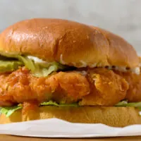 Crispy Chicken Burger topped with lettuce, pickles, and mayo.