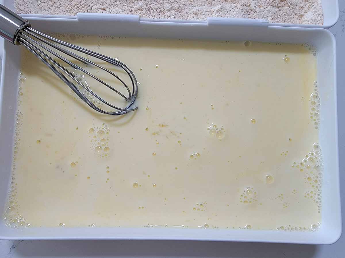 egg and milk mixture whisked in a coating tray.