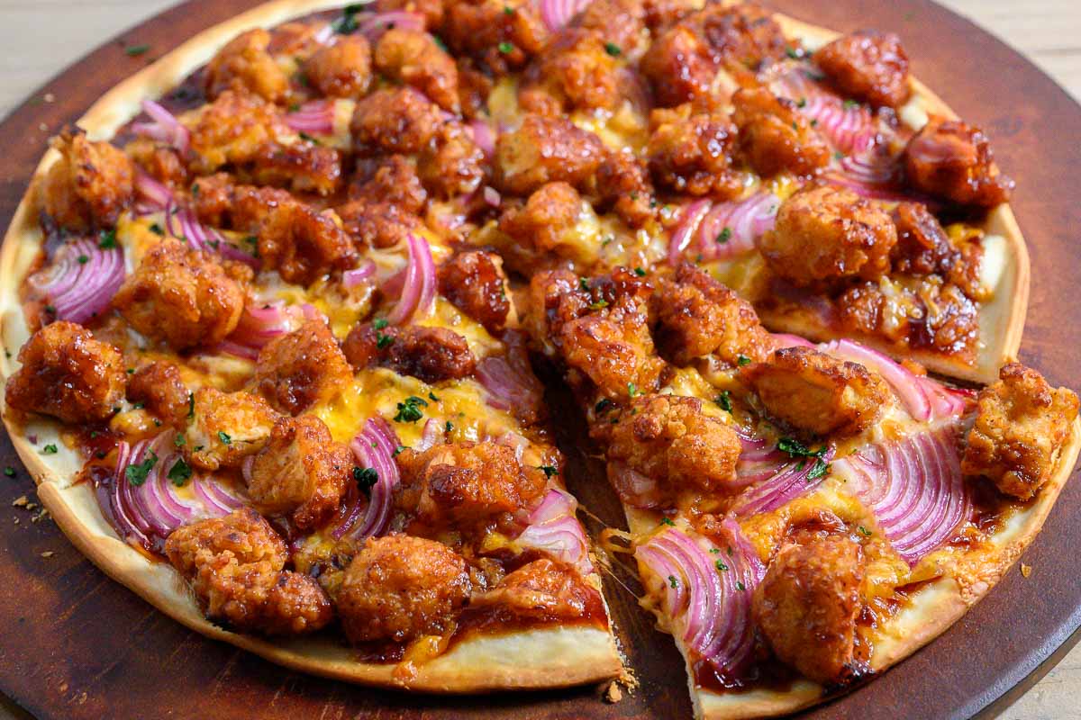 Nugget Pizza on a pizza stone.