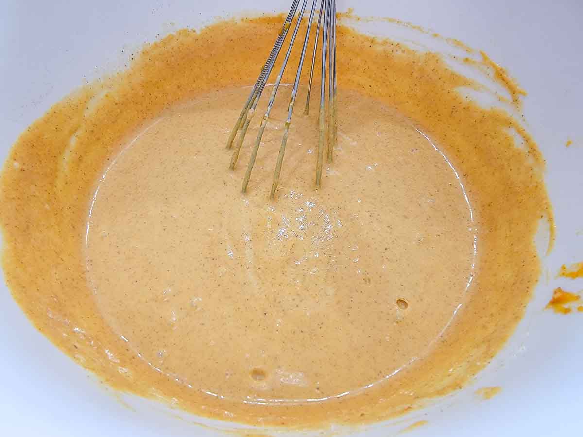 pumpkin pie filling whisked in a bowl.