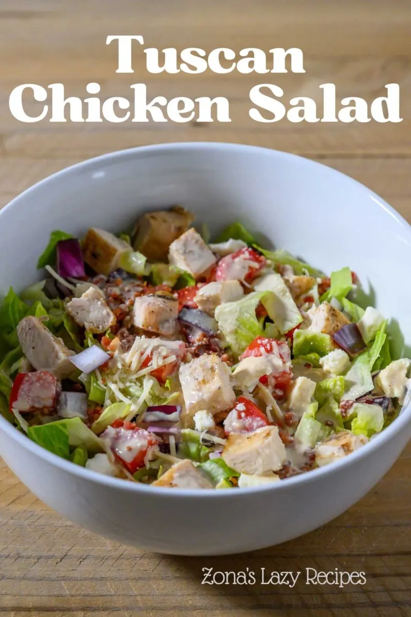 Tuscan Chicken Salad in a bowl topped with a mayo and Dijon vinaigrette