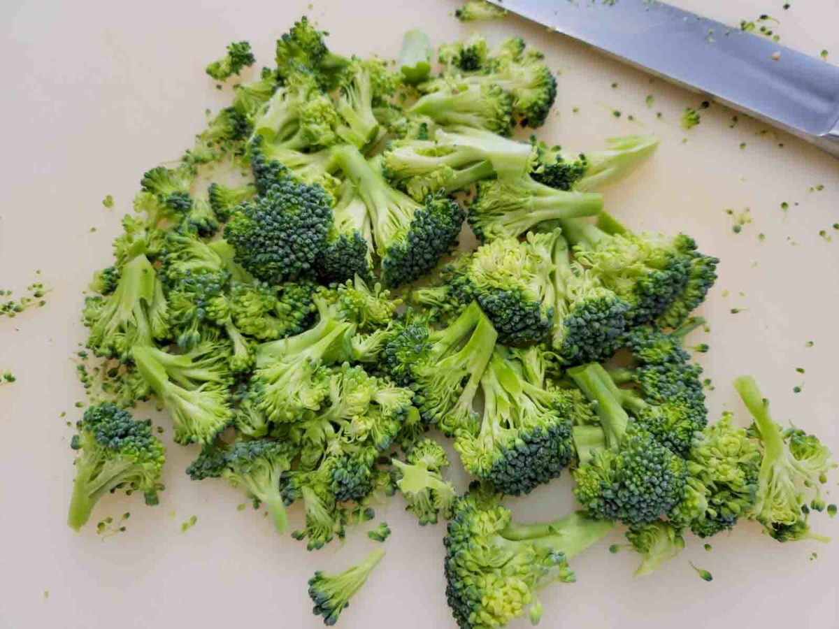 broccoli chopped on a cutting board.