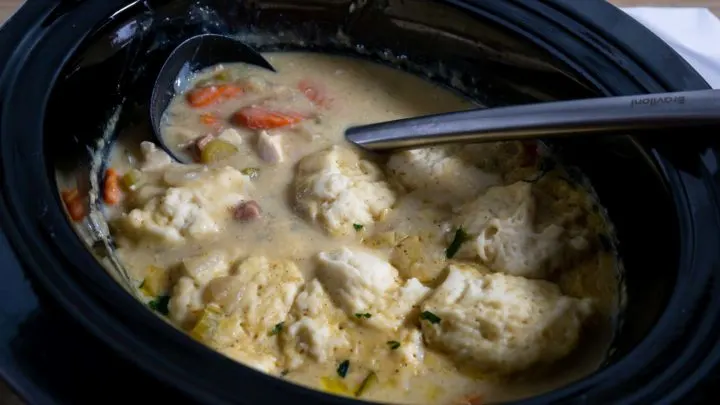 Slow Cooker Stew and Dumplings in a slow cooker pot.