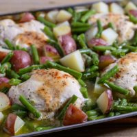 Italian Chicken Green Beans and Potatoes on a sheet pan filled with boneless chicken, red potatoes and green beans.