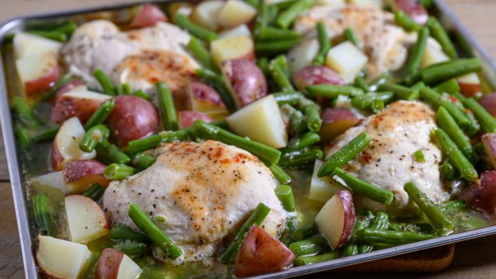 Italian Chicken Green Beans and Potatoes on a sheet pan filled with boneless chicken, red potatoes and green beans.