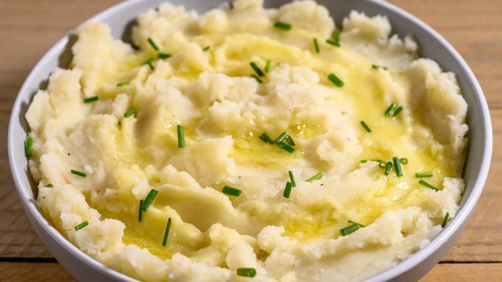 Homemade Mashed Potatoes without Milk topped with melted butter and chives.