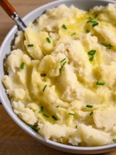 Mashed Potatoes Recipe without Milk topped with butter and chives.