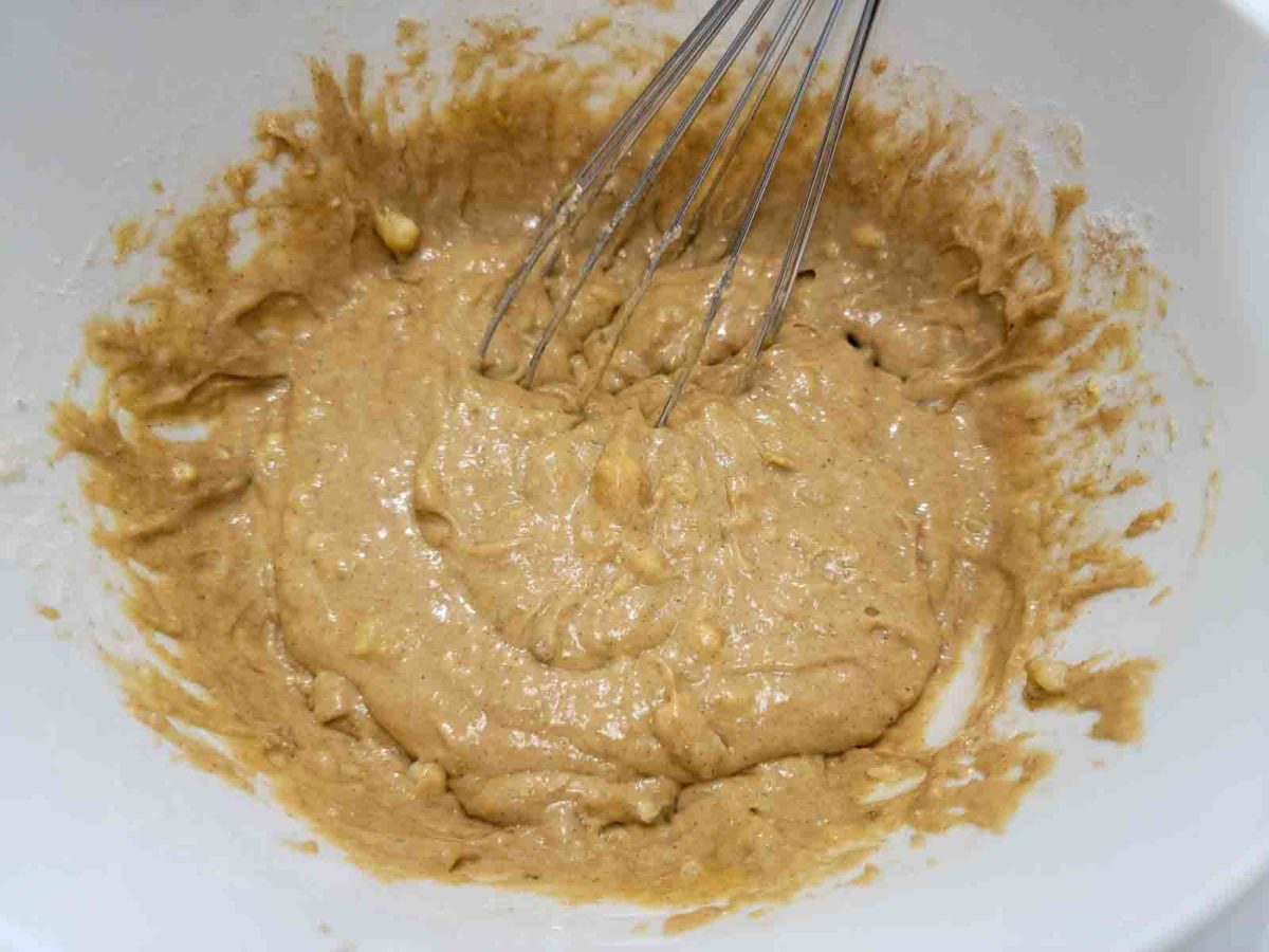 spice cake mix, bananas, and egg whisked in a bowl.