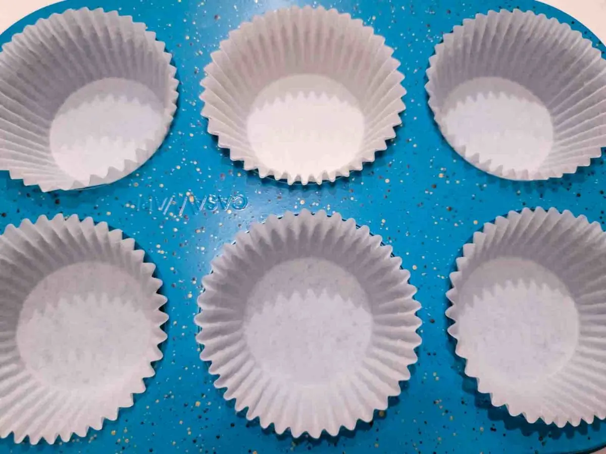paper muffin liners in a muffin tin.