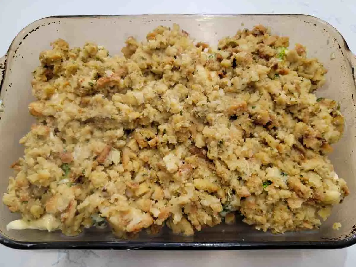 stuffing layered over chicken mixture in a baking dish.