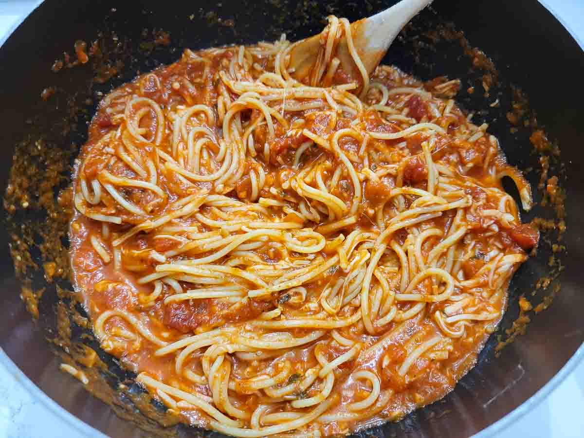 spaghetti with the marinara sauce, a third of the Parmesan cheese, and 1 cup of mozzarella in a saucepan.