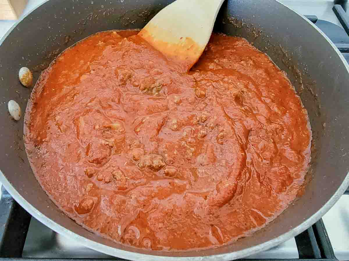 spaghetti sauce cooking in a pan.