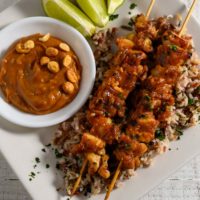 Thai Chicken Skewers with Peanut Sauce over rice.