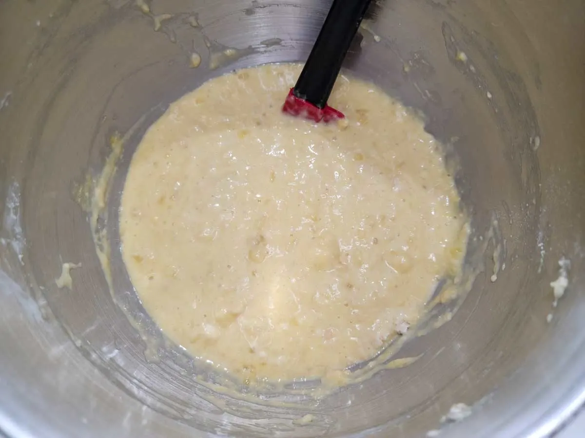 mashed banana, eggs, sugar, baking soda, and self-rising flour mixed in a bowl.