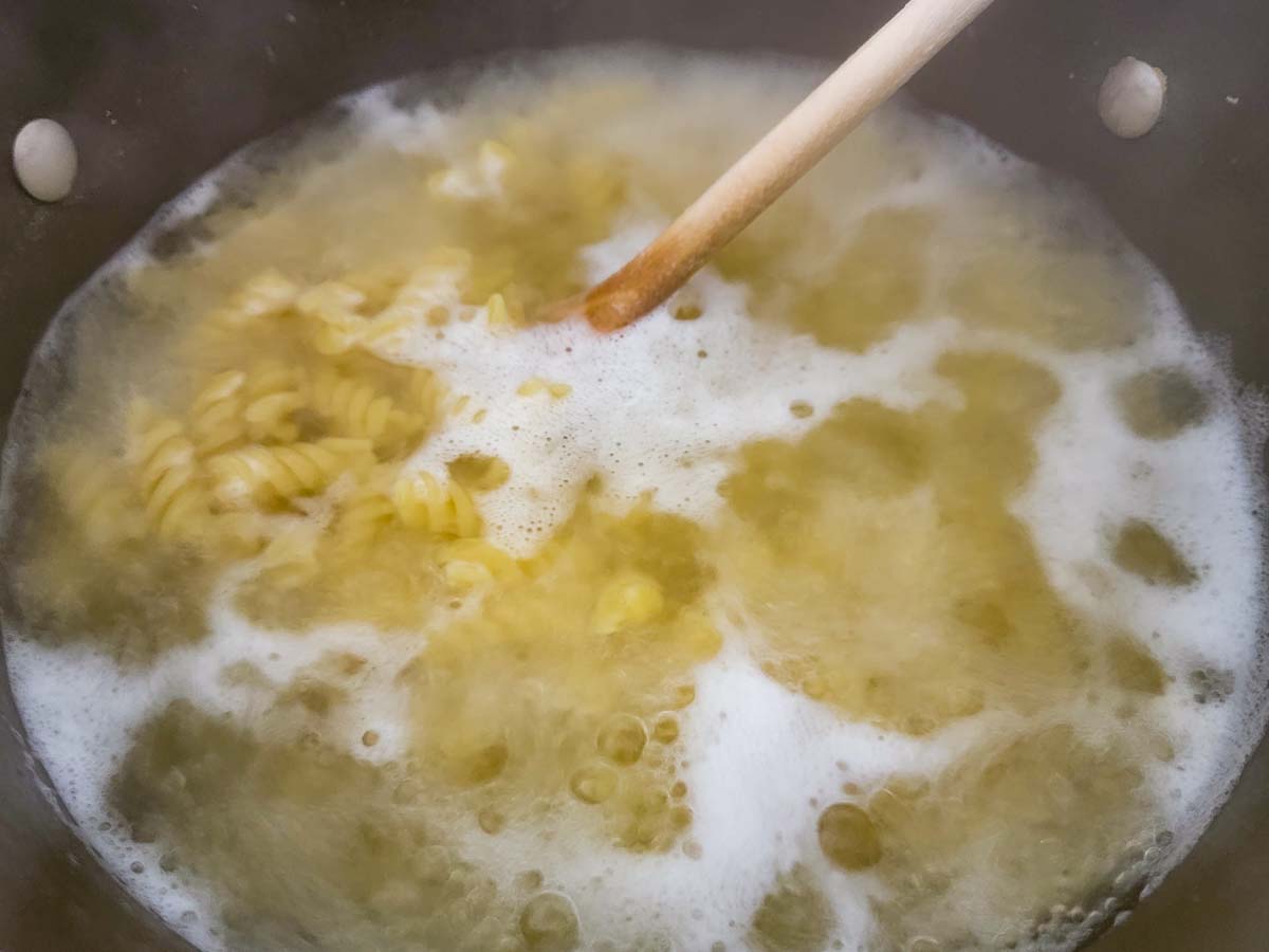 rotini pasta boiling in a pan.