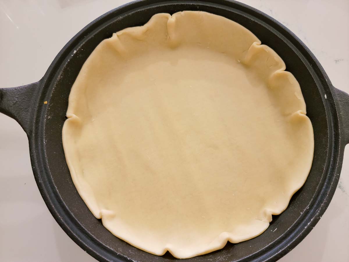 pie crust in the bottom of a 10-inch cast iron skillet.