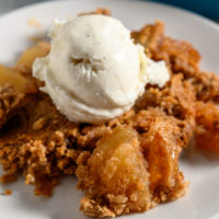 3 Ingredient Apple Dump Cake topped with ice cream.