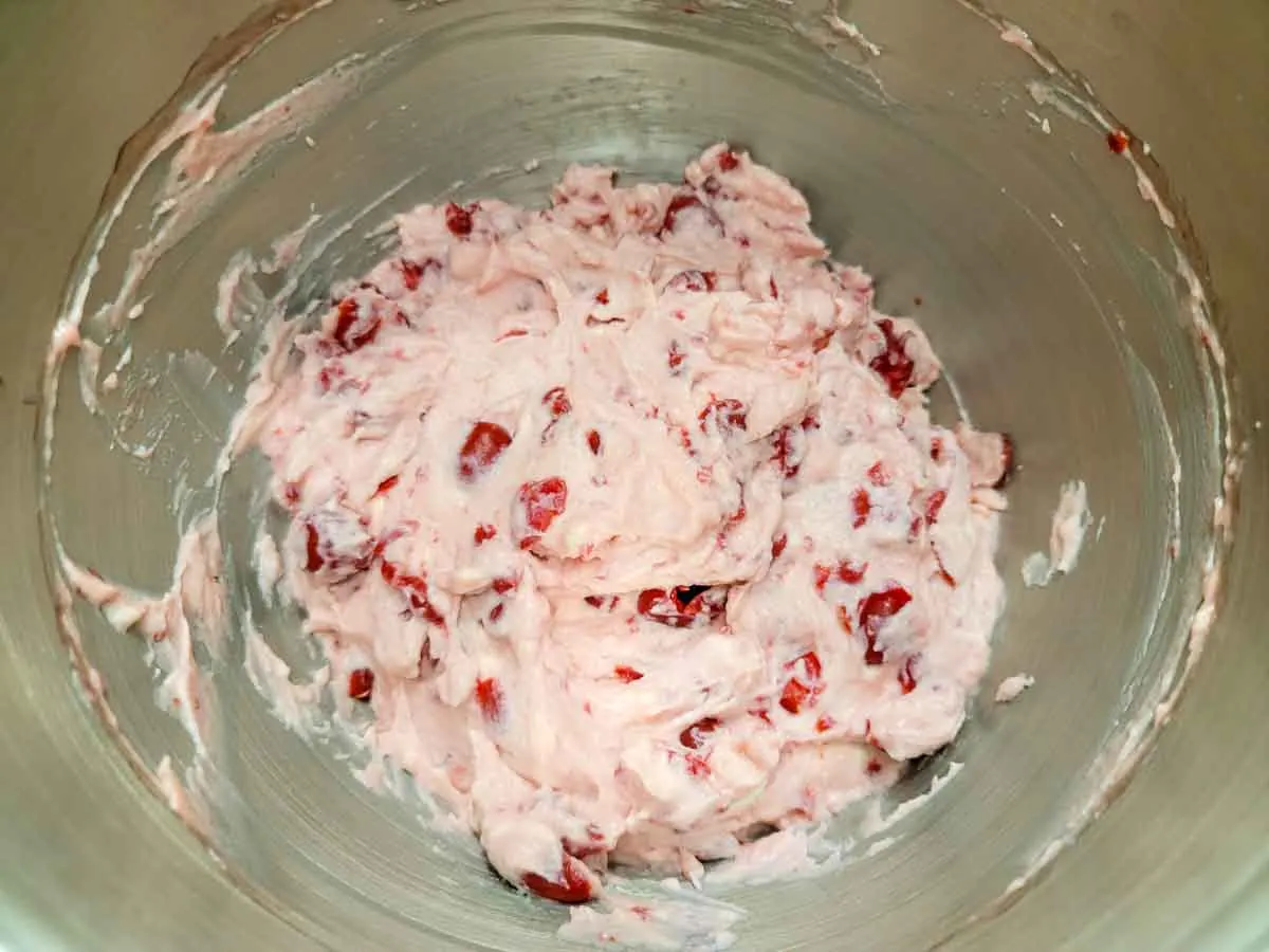 cherry cheesecake batter in a mixing bowl.