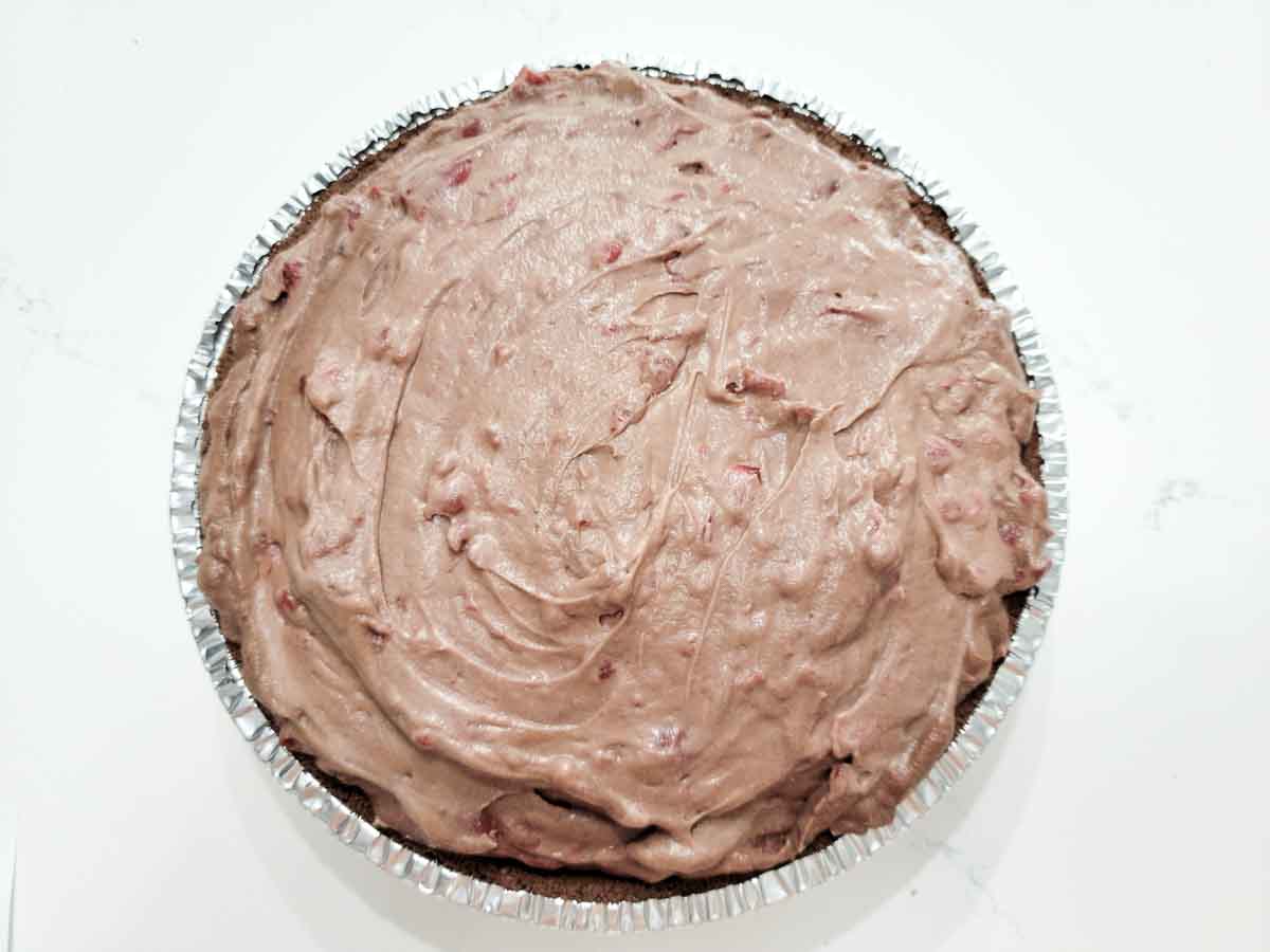 chocolate cherry cheesecake in a pie pan.