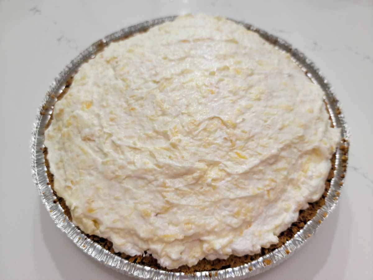 no bake pineapple pie in a pecan crust ready to chill.