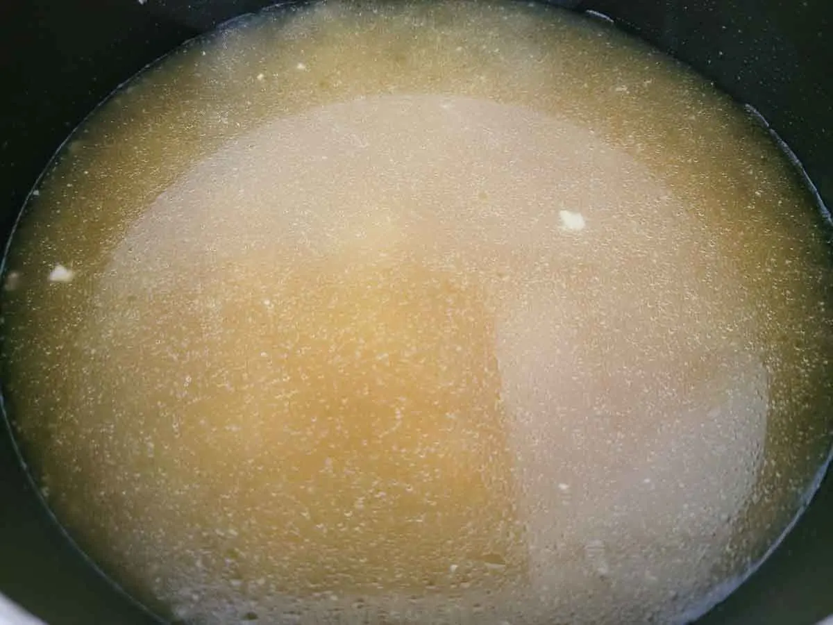 chicken broth cooking in a pan.