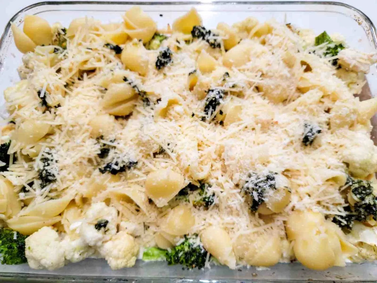 Chicken Broccoli Cauliflower Pasta topped with cheese in a baking dish.