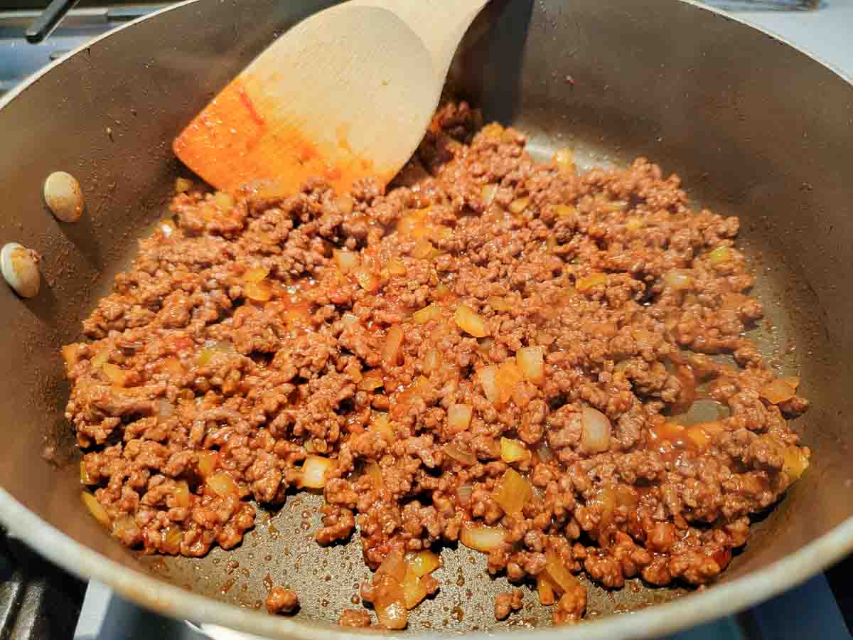 sloppy joes cooking in a skillet.