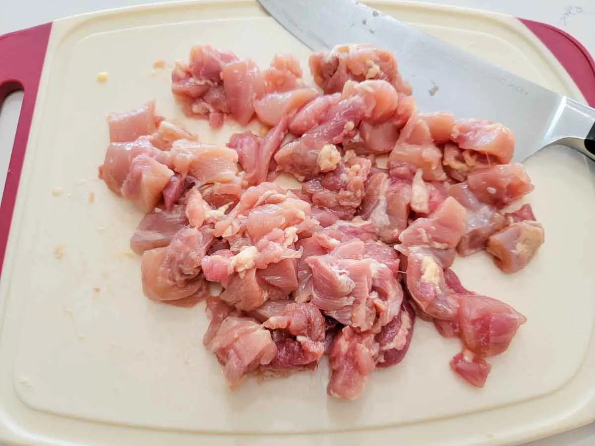 chicken diced on a cutting board.