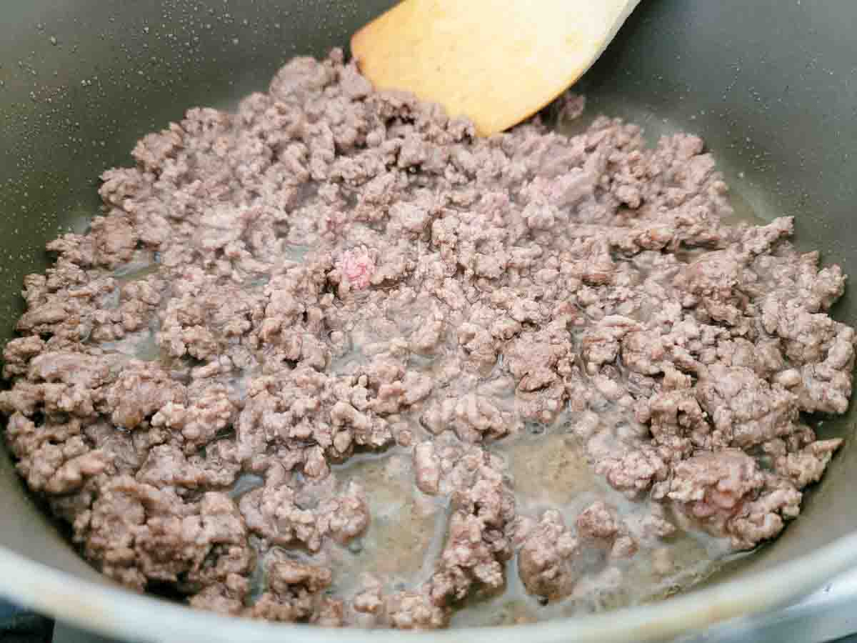 ground beef cooking in a pan.
